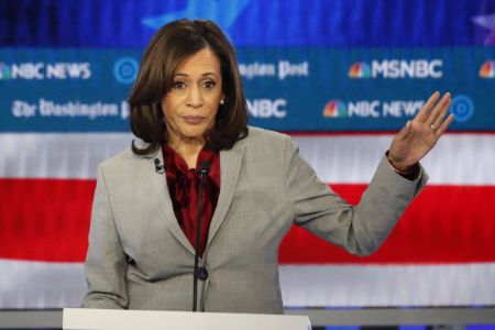 Kamala Harris in a grey suit poses for a picture.